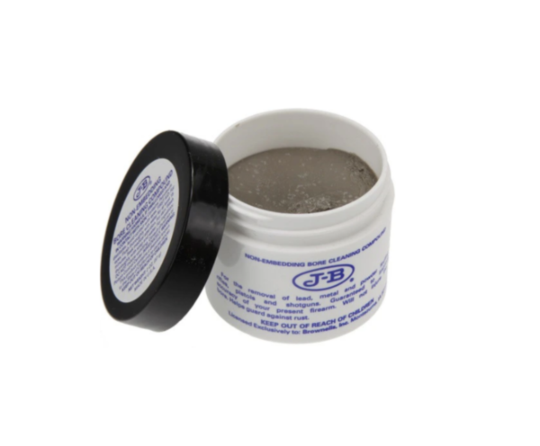 Open white container of JB Bore cleaning paste with blue text on the label, next to a black lid leaning against it.